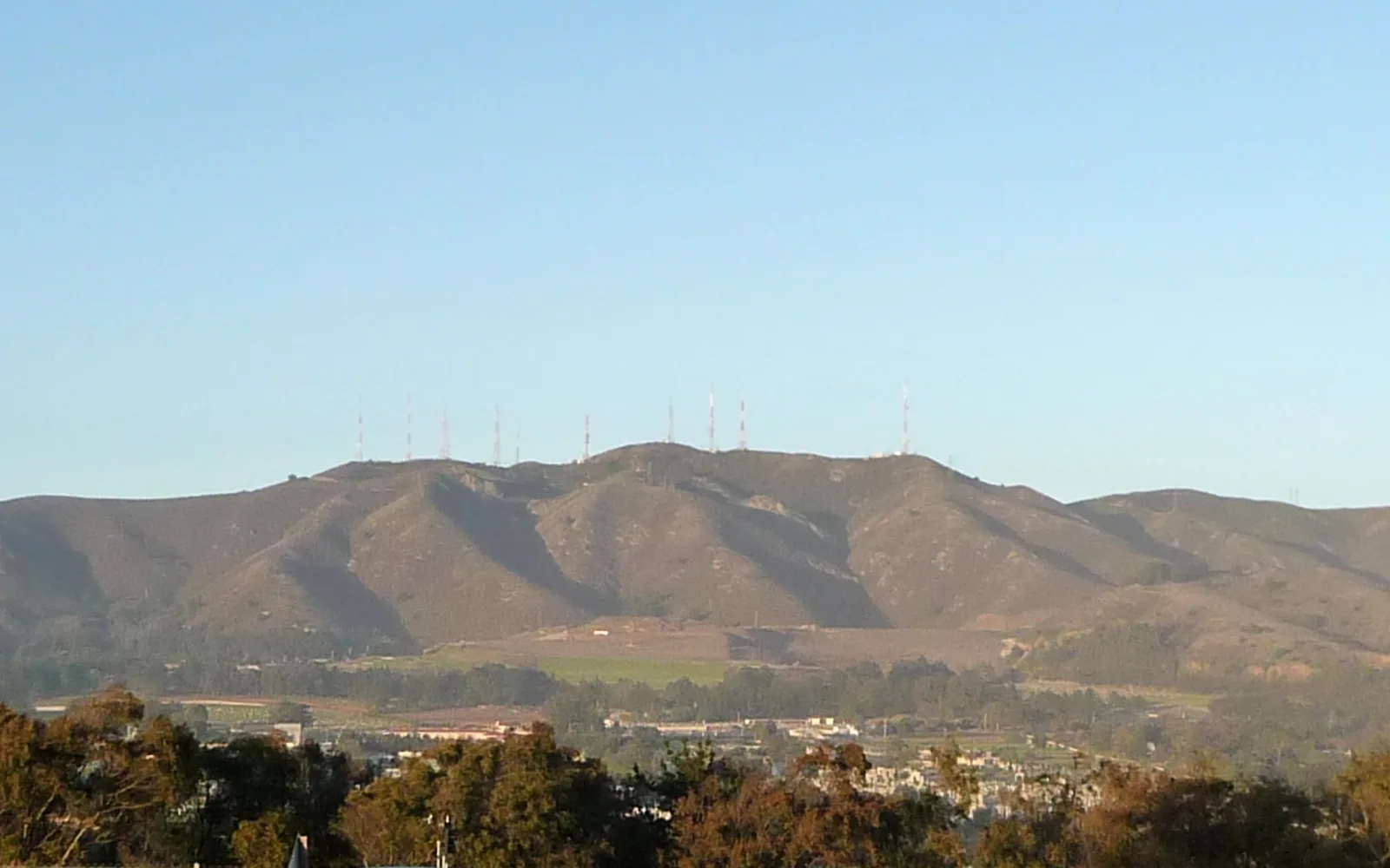 San Bruno Mountain rises in the distance above the surrounding Peninsula community, photographed from Daly City